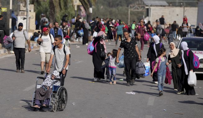 Palestinians flee to the southern Gaza Strip along Salah al-Din Street in Bureij, Gaza Strip, Thursday, Nov. 9, 2023. ( AP Photo/Hatem Moussa)