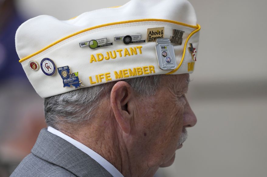 Carroll Davis Jr., a United States Marine Corp veteran, and adjutant with the Disabled American Veterans Department of Mississippi, wears his "cover" decorated with DAV volunteer pins while being recognized at a Veterans Day Ceremony at the Two Mississippi Museums in Jackson, Miss., Thursday, Nov. 9, 2023. (AP Photo/Rogelio V. Solis)