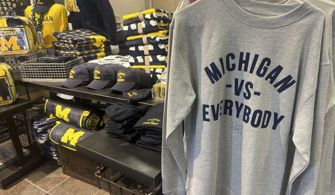 Michigan Vs. Everybody knit hats, ball caps, sweatshirts and T-shirts were flying off the racks and plucked off a table at The M Den, a retail store near the University of Michigan campus in Ann Arbor, Mich. Sunday, Nov. 12, 2023. The second-ranked Wolverines headed into a fateful week with a court hearing, a road trip to Maryland and a swagger built on their growing belief that it鈥檚 them against the world. The school is preparing for its legal battle fight to free Jim Harbaugh from a Big Ten suspension. (AP Photo/Larry Lage)