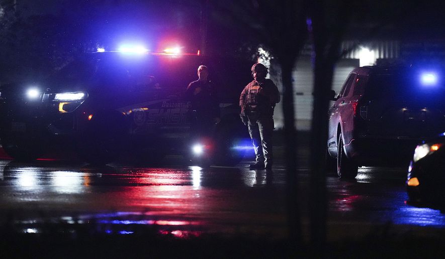 Members of Brazoria County Sheriff's Department block the road leading to Cole's Antique Village and Flea Market after a shooting outside, Sunday, Nov. 12, 2023, in Pearland, Texas, near Houston. A manhunt was underway late Sunday after a gunman shot at least five people outside the flea market. The five, identified by police as three adults and two juveniles, were taken to local hospitals, Pearland police said. (Elizabeth Conley/Houston Chronicle via AP)