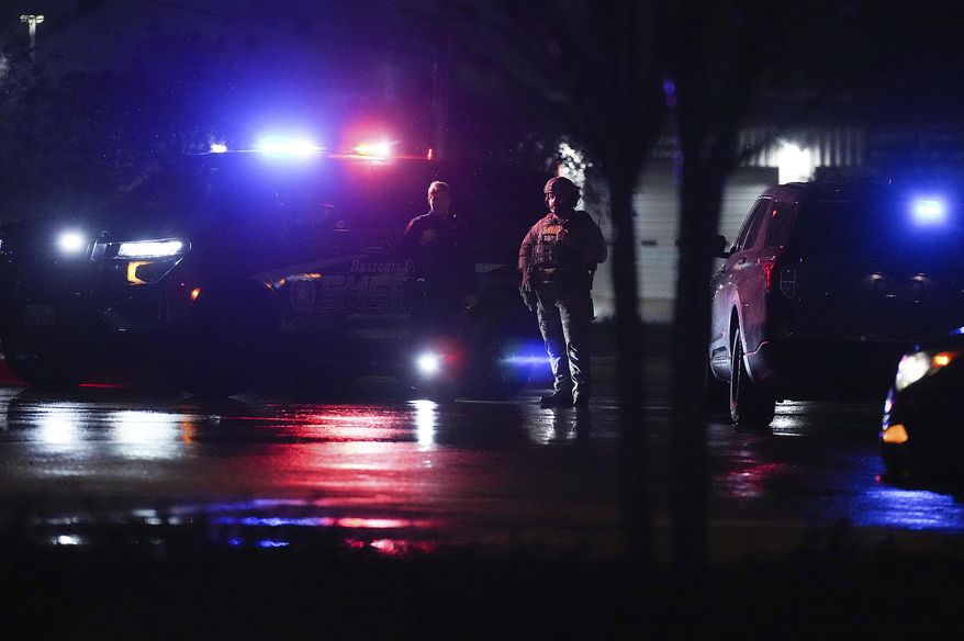 Members of Brazoria County Sheriff's Department block the road leading to Cole's Antique Village and Flea Market after a shooting outside, Sunday, Nov. 12, 2023, in Pearland, Texas, near Houston. A manhunt was underway late Sunday after a gunman shot at least five people outside the flea market. The five, identified by police as three adults and two juveniles, were taken to local hospitals, Pearland police said. (Elizabeth Conley/Houston Chronicle via AP)
