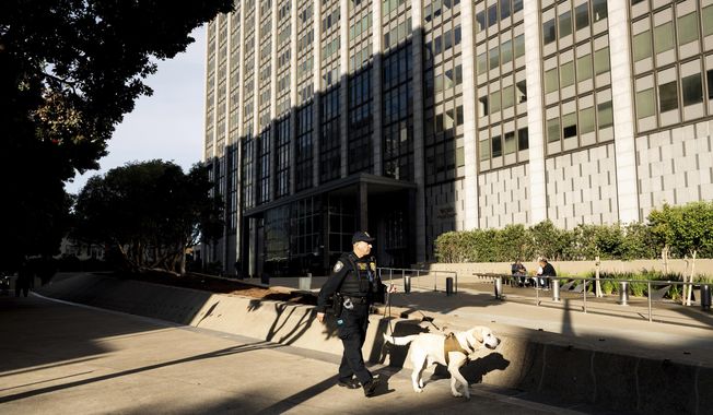 A Department of Homeland Security officer walks the perimeter of the Phillip Burton Federal Building and U.S. Courthouse where the federal trial of David DePape is underway in San Francisco, on Monday, Nov. 13, 2023. Prosecutors say DePape broke into former House Speaker Nancy Pelosi&#x27;s home and bludgeoned her husband Paul Pelosi with a hammer in October 2022. (AP Photo/Noah Berger)