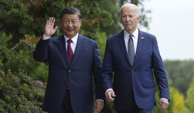 President Joe Biden and China&#x27;s President President Xi Jinping walk in the gardens at the Filoli Estate in Woodside, Calif., Wednesday, Nov, 15, 2023, on the sidelines of the Asia-Pacific Economic Cooperative conference. (Doug Mills/The New York Times via AP, Pool)
