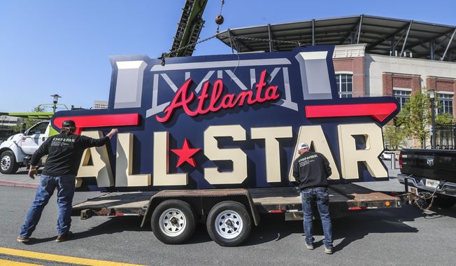 Workers load an All-Star sign onto a trailer after it was removed from Truist Park in Atlanta, Tuesday, April 6, 2021. Major League Baseball will play its 2025 All-Star Game in Atlanta, four years after moving the game from Truist Park to Denver鈥檚 Coors Field over objections to changes in Georgia鈥檚 votings rights laws. Baseball Commissioner Rob Manfred made the announcement Thursday, Nov. 16, 2023, following an owners鈥� meeting. (John Spink/Atlanta Journal-Constitution via AP, File) **FILE**