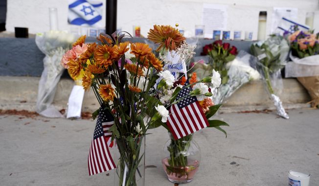 Flowers and flags are left at a makeshift shrine placed at the scene of a Sunday confrontation that lead to death of a demonstrator Tuesday, Nov. 7, 2023, in Thousand Oaks, Calif. Paul Kessler, 69, died at a hospital on Monday from a head injury after witnesses reported he was involved in a &quot;physical altercation&quot; during pro-Israel and pro-Palestinian demonstrations at an intersection in Thousand Oaks, a suburb northwest of Los Angeles, authorities said. (AP Photo/Richard Vogel)