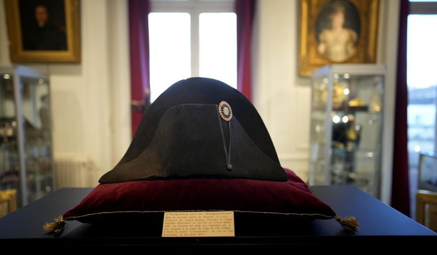 One of the signature broad, black hats that Napol茅on wore when he ruled 19th century France and waged war in Europe is on display at Osenat&#x27;s auction house in Fontainebleau, south of Paris, Friday, Nov. 17, 2023. The hat is tipped to fetch more than half a million euros (dollars) at the auction Sunday of Napoleonic memorabilia patiently collected by a French industrialist. (AP Photo/Christophe Ena)