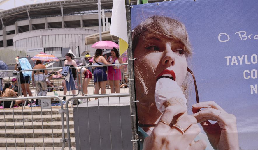Taylor Swift fans wait for the doors of Nilton Santos Olympic stadium to open for her Eras Tour concert amid a heat wave in Rio de Janeiro, Brazil, Saturday, Nov. 18, 2023. A 23-year-old Taylor Swift fan died at the singer&#x27;s Eras Tour concert in Rio de Janeiro Friday night, according to a statement from the show&#x27;s organizers in Brazil.  (AP Photo/Silvia Izquierdo)