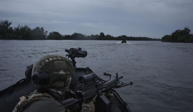 Ukrainian soldiers navigate on the Dnipro river by boat at the frontline near Kherson, Ukraine, Sunday, June 11, 2023. (AP Photo/Felipe Dana)