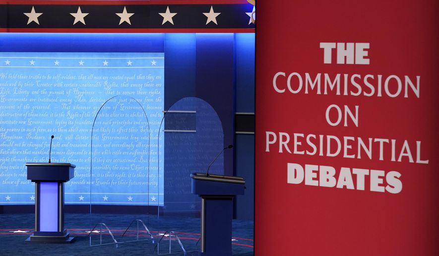 FILE - Clear protective panels stand onstage between lecterns as preparations take place for the second Presidential debate at Belmont University, Oct. 21, 2020, in Nashville, Tenn. Three debates for next year's presidential general election are set to be held in college towns in Texas, Virginia and Utah between Sept. 16 and Oct. 9, with the lone vice presidential debate happening in-between in Pennsylvania — though whether the Republican nominee will participate remains to be seen. The nonpartisan Commission on Presidential Debates announced Monday, Nov. 20, 2023, that presidential candidates will first be scheduled to meet Sept. 16. (AP Photo/Patrick Semansky, File)