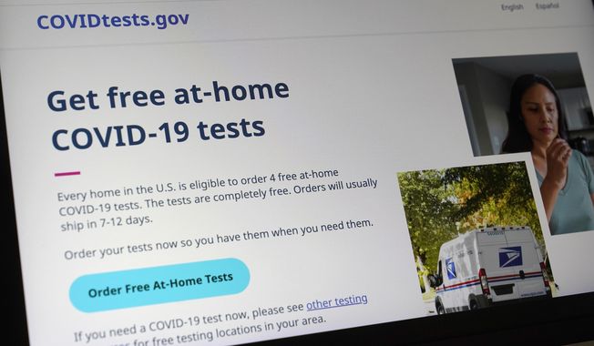 A United States government website is displayed on a computer, Wednesday, Jan. 19, 2022, in Walpole, Mass., that features a page where people can order free, at-home COVID-19 tests. (AP Photo/Steven Senne, File)