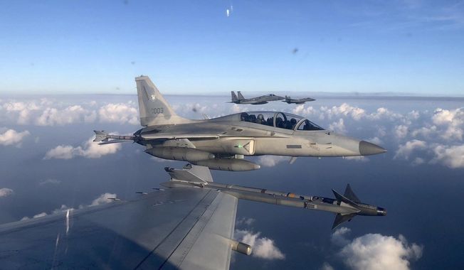 In this handout photo released by the Philippine Air Force, a Philippine Air Force FA-50PH jet fighter, joins the maritime patrol of the Philippines and the United States over Batanes and areas in the West Philippine Sea on Tuesday, Nov. 21, 2023. The United States and Philippines are conducting joint air and maritime patrols in the South China Sea, which come as the two countries step up cooperation in the face of growingly aggressive Chinese activity in the area. (Philippine Air Force via AP)