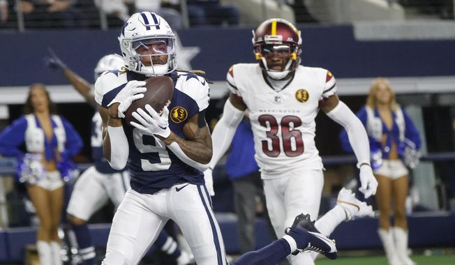 Dallas Cowboys wide receiver KaVontae Turpin (9) catches a touchdown pass in front of Washington Commanders cornerback Danny Johnson (36) during the second half of an NFL football game Thursday, Nov. 23, 2023, in Arlington, Texas. (AP Photo/Michael Ainsworth)