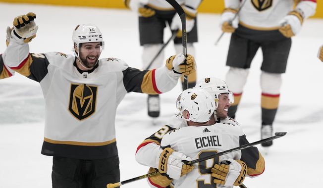 Vegas Golden Knights center Jack Eichel (9) celebrates with teammates his game-winning goal against the Dallas Stars during overtime of an NHL hockey game, Wednesday, Nov. 22, 2023, in Dallas. The Golden Knights won 2-1. (AP Photo/Tony Gutierrez)