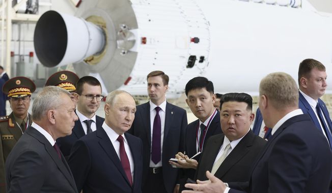 Russian President Vladimir Putin and North Korea&#x27;s leader Kim Jong-un examine a rocket assembly hangar during their meeting at the Vostochny cosmodrome outside the city of Tsiolkovsky, about 200 kilometers (125 miles) from the city of Blagoveshchensk in the far eastern Amur region, Russia, on Wednesday, Sept. 13, 2023. Russian Federal Space Corporation Roscosmos CEO Yuri Borisov is on the left. South Korea assessed that it was likely Russian support that enabled North Korea to put a spy satellite into orbit for the first time this week and that foreign countries can find if the satellite can perform reconnaissance functions by early next week, Seoul officials said Thursday, Nov. 23. (Artyom Geodakyan, Sputnik, Kremlin Pool Photo via AP, File)