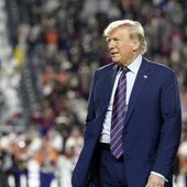 Republican presidential candidate and former President Donald Trump stands on the field during halftime in an NCAA college football game between the University of South Carolina and Clemson on Saturday, Nov. 25, 2023, in Columbia, S.C. (AP Photo/Meg Kinnard) **FILE**