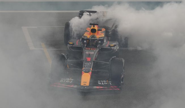 Red Bull driver Max Verstappen of the Netherlands spins in his car as he celebrates winning the Abu Dhabi Formula One Grand Prix race at the Yas Marina Circuit, Abu Dhabi, UAE, Sunday, Nov. 26, 2023. (AP Photo/Kamran Jebreili)