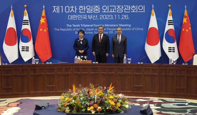 Chinese Foreign Minister Wang Yi, right, South Korean Foreign Minister Park Jin, center, and Japanese Foreign Minister Yoko Kamikawa pose for a photo prior to the trilateral foreign ministers&#x27; meeting in Busan, South Korea, Sunday, Nov. 26, 2023.(AP Photo/Ahn Young-joon, Pool)