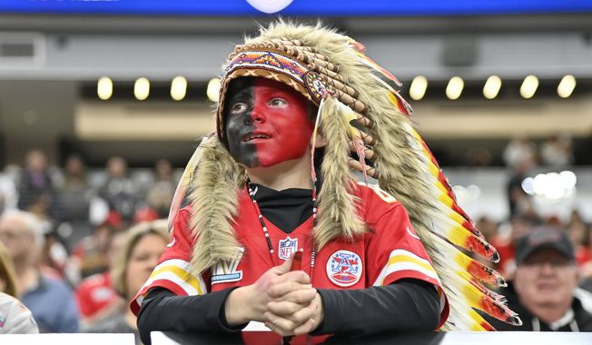 A young Kansas City Chiefs fan, dressed with a headdress and face paint, looks on during an NFL football game against the Las Vegas Raiders, Sunday, Nov. 26, 2023, in Las Vegas. (AP Photo/David Becker)