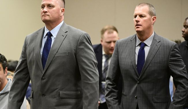Paramedics Jeremy Cooper, left, and Peter Cichuniec, right, attend an arraignment at the Adams County Justice Center in Brighton, Colo., on Jan. 20, 2023. The third and final trial over the 2019 death of Elijah McClain after he was stopped by police in suburban Denver involves homicide and manslaughter charges against two paramedics, a prosecution experts say enters largely uncharted legal territory by levying criminal charges against medical first responders. (Andy Cross/The Denver Post via AP, file)