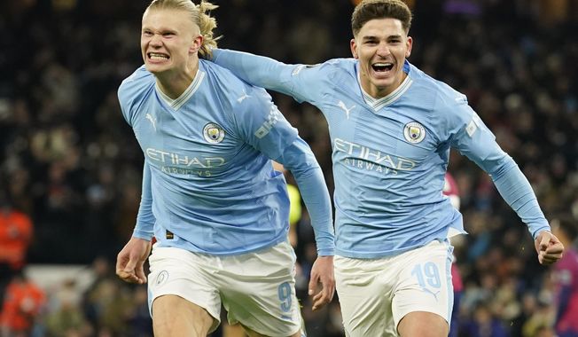 Manchester City&#x27;s Julian Alvarez, right, celebrates with Manchester City&#x27;s Erling Haaland after scoring his side&#x27;s third goal during the group G Champions League soccer match between Manchester City and RB Leipzig at the Etihad stadium in Manchester, England, Tuesday, Nov. 28, 2023. (AP Photo/Dave Thompson)