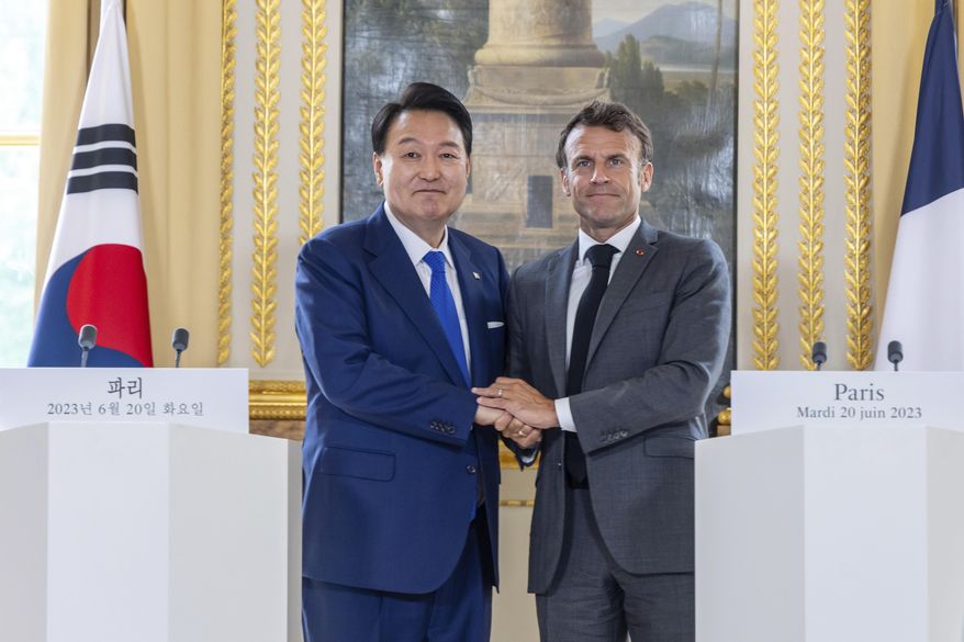 French President Emmanuel Macron and South Korean President Yoon Suk Yeol shake hands after a joint press conference at Elysee palace in Paris, on June 20 2023. The Bureau International des Expositions (BIE) will cast their votes in Paris Tuesday, Nov. 28, 2023 to determine the host city for the 2030 World Expo, with Rome, Busan, and Riyadh as the leading contenders. Each city has ramped up their campaigns, pulling out all the stops in a fervent display to secure this prestigious event. (Christophe Petit Tesson, Pool via AP, File)