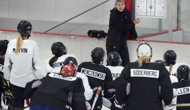 Courtney Kessel, head coach of the Boston-based team of the Professional Women&#x27;s Hockey League, instructs her players during a team hockey practice ahead of their season, Monday, Nov. 20, 2023, in Wellesley, Mass. Puck drop will follow the New Year&#x27;s ball drop for the the newly established Professional Women&#x27;s Hockey League in kicking off its inaugural schedule with Toronto hosting New York on Jan. 1. (AP Photo/Charles Krupa)