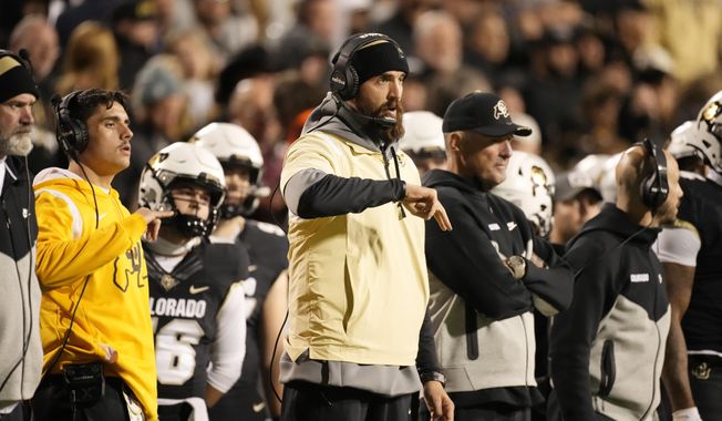Colorado offensive coordinator Sean Lewis gestures in the second half of an NCAA college football game, Nov. 4, 2023, in Boulder, Colo. Lewis, who was stripped of his play-calling duties as Colorado&#x27;s offensive coordinator late in the season, is being hired as head coach at San Diego State, a person with knowledge of the situation said Tuesday, Nov. 28. (AP Photo/David Zalubowski, File)