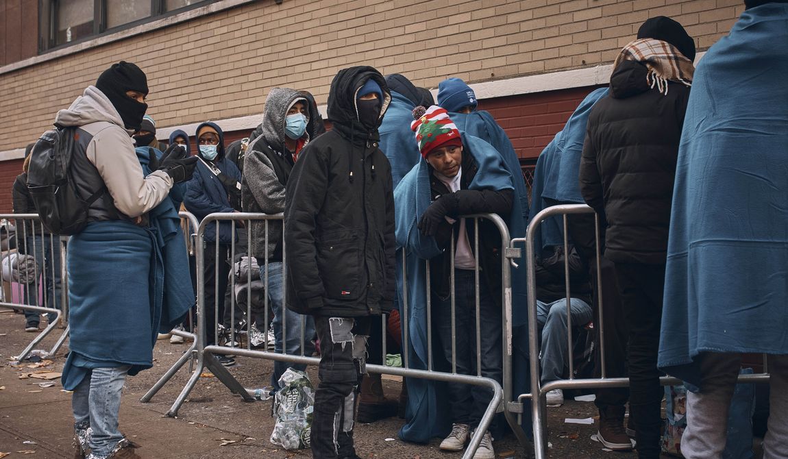 Migrants wait in the cold as they look for a shelter outside a Migrant Assistance Center at St. Brigid Elementary School on Wednesday, Nov. 29, 2023, in New York. (AP Photo/Andres Kudacki)