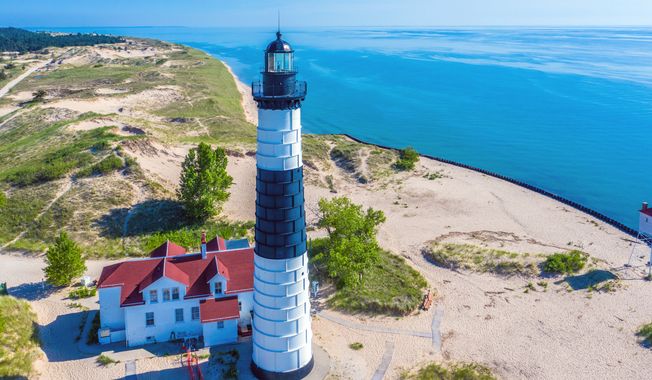The Big Sable Point Lighthouse near Ludington, Michigan stands in Ludington State Park. A pair of newlyweds from Indiana died along with their two dogs when their single-engine plane crashed just after takeoff at Mason County Airport in Ludington, Michigan. (File Photo credit: Frederick Millett via Shutterstock)