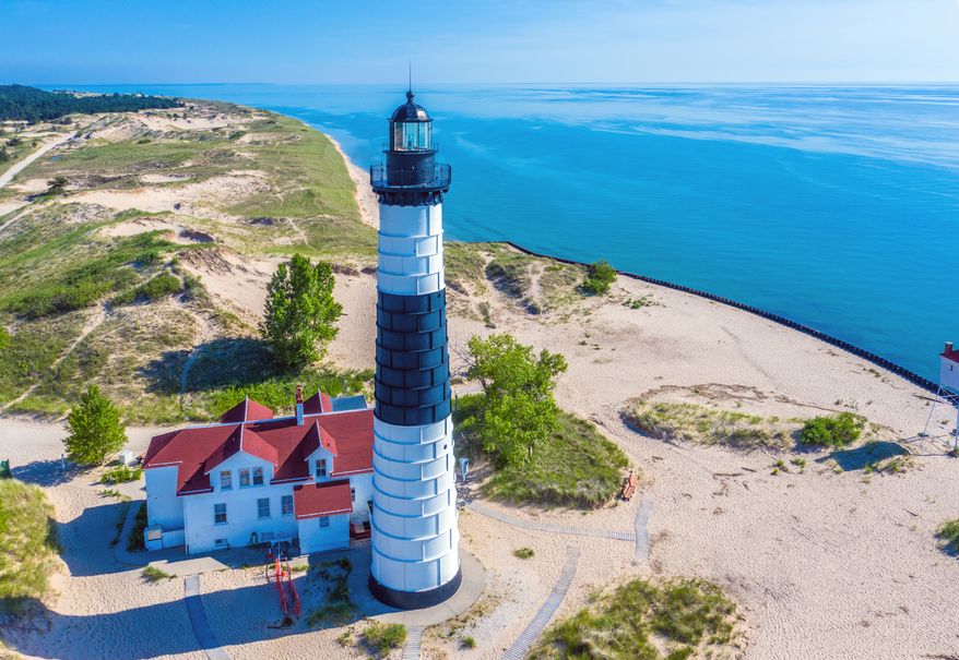 The Big Sable Point Lighthouse near Ludington, Michigan stands in Ludington State Park. A pair of newlyweds from Indiana died along with their two dogs when their single-engine plane crashed just after takeoff at Mason County Airport in Ludington, Michigan. (File Photo credit: Frederick Millett via Shutterstock)