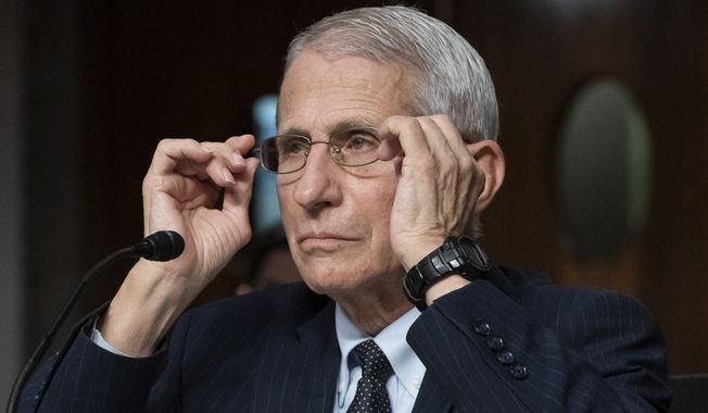 Dr. Anthony Fauci, director of the National Institute of Allergy and Infectious Diseases, adjusts his glasses during a Senate Health, Education, Labor, and Pensions Committee hearing on Capitol Hill, Nov. 4, 2021, in Washington. Fauci is expected to testify before Congress early next year as part of Republicans鈥� yearslong investigation into the origins of COVID-19 and the U.S. response to the disease. Fauci will sit for transcribed interviews in early January and a public hearing at a later date. (AP Photo/Alex Brandon, File)