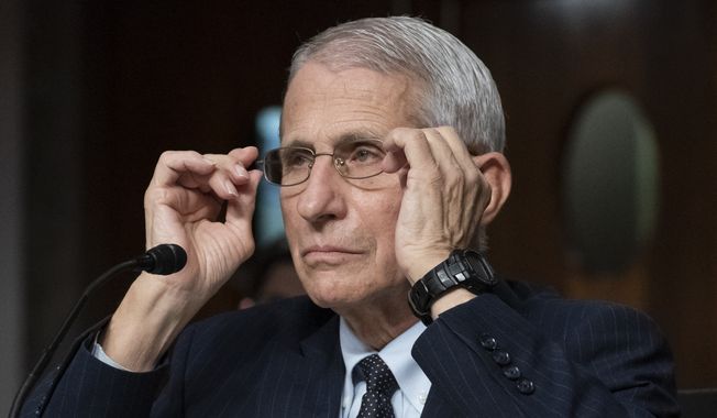 Dr. Anthony Fauci, director of the National Institute of Allergy and Infectious Diseases, adjusts his glasses during a Senate Health, Education, Labor, and Pensions Committee hearing on Capitol Hill, Nov. 4, 2021, in Washington. Fauci is expected to testify before Congress early next year as part of Republicans’ yearslong investigation into the origins of COVID-19 and the U.S. response to the disease. Fauci will sit for transcribed interviews in early January and a public hearing at a later date. (AP Photo/Alex Brandon) **FILE**