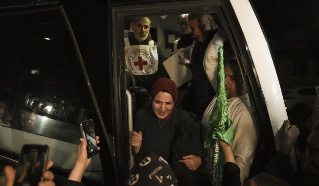 A woman smiles as she is welcomed after being released from prison by Israel, in the West Bank town of Ramallah, early Thursday, Nov. 30, 2023. International mediators on Wednesday worked to extend the truce in Gaza, encouraging Hamas militants to keep freeing hostages in exchange for the release of Palestinian prisoners and further relief from Israel&#x27;s air and ground offensive. (AP Photo/Nasser Nasser)