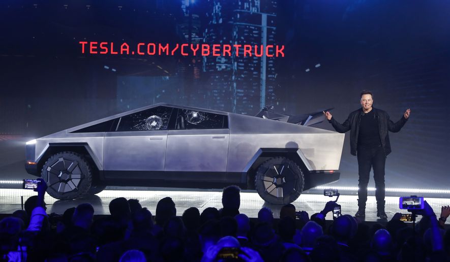 Tesla CEO Elon Musk introduces the Cybertruck at Tesla&#x27;s design studio on Nov. 21, 2019, in Hawthorne, Calif. The windows were broken during a demonstration intended to show the strength of the glass. Musk is expected to give an update on manufacturing problems with the long-awaited Cybertruck at an event Thursday marking the first deliveries of the futuristic, angular pickup truck. (AP Photo/Ringo H.W. Chiu)