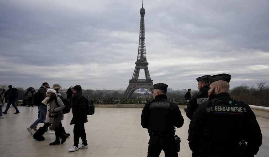 French gendarmes patrol the Trocadero plaza near the Eiffel Tower after a man targeted passersbys late saturday, killing a German tourist with a knife and injuring two others in Paris, Sunday, Dec. 3, 2023. Police subdued the man, a 25-year-old French citizen who had spent four years in prison for a violent offense. After his arrest, he expressed anguish about Muslims dying, notably in the Palestinian territories. (AP Photo/Christophe Ena)