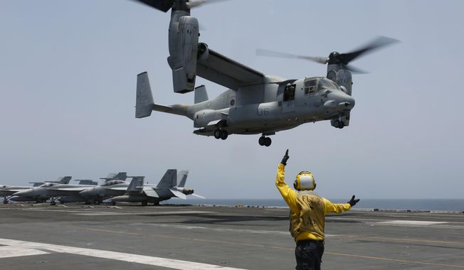 In this image provided by the U.S. Navy, Aviation Boatswain&#x27;s Mate 2nd Class Nicholas Hawkins, signals an MV-22 Osprey to land on the flight deck of the USS Abraham Lincoln in the Arabian Sea on May 17, 2019. When the U.S. military took the extraordinary step of grounding its fleet of V-22 Ospreys this week, it wasn&#x27;t reacting just to the recent deadly crash of the aircraft off the coast of Japan. The aircraft has had a long list of problems in its short history. (Mass Communication Specialist 3rd Class Amber Smalley/U.S. Navy via AP) ** FILE **