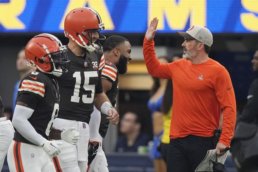Los Angeles Rams head coach Kevin Stefanski, right, celebrates with quarterback Joe Flacco (15) after at touchdown catch by Jerome Ford during the first half of an NFL football game against the Los Angeles Rams, Sunday, Dec. 3, 2023, in Inglewood, Calif. (AP Photo/Mark J. Terrill)