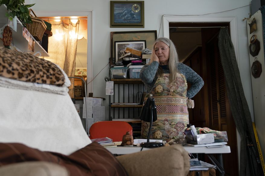 Nancy Rose, who contracted COVID-19 in 2021 and exhibits long-haul symptoms including brain fog and memory difficulties, pauses while organizing her desk space, Tuesday, Jan. 25, 2022, in Port Jefferson, N.Y. Rose, 67, said many of her symptoms waned after she got vaccinated, though she still has bouts of fatigue and memory loss. U.S. health officials estimate 3.3 million Americans have chronic fatigue syndrome — a bigger number than previous studies have suggested, and one likely boosted by patients with long COVID, according to results released by the Centers for Disease Control and Prevention on Friday, Dec. 8, 2023. (AP Photo/John Minchillo, File)