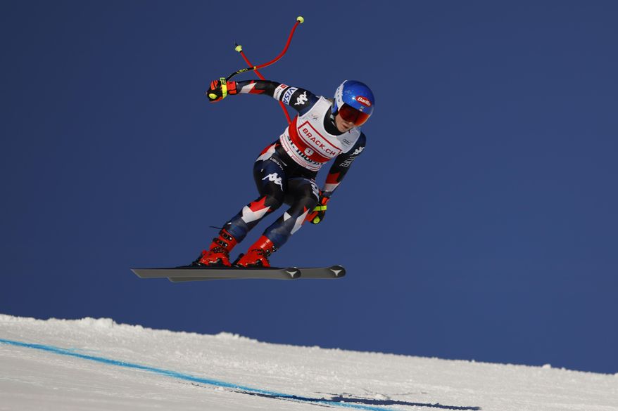 United States' Mikaela Shiffrin is airborne during an alpine ski, women's World Cup downhill race, in St. Moritz, Switzerland, Saturday, Dec.9, 2023. (AP Photo/Giovanni Maria Pizzato)