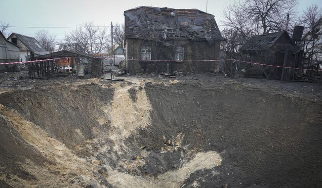 A general view of the crater at a site of recent Russian missile attack in Kyiv, Ukraine, Monday, Dec. 11, 2023. (AP Photo/Efrem Lukatsky)