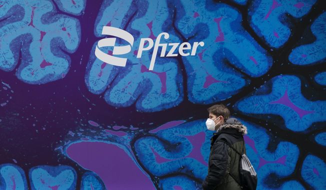 A man walks by Pfizer headquarters, Friday, Feb. 5, 2021 in New York. Pfizer released a financial outlook for next year that that doesn&#x27;t match with Wall Street expectations as sales of COVID-19 products slide. Shares tumbled more than 7% before the opening bell Wednesday, Dec. 13, 2023. (AP Photo/Mark Lennihan, File)
