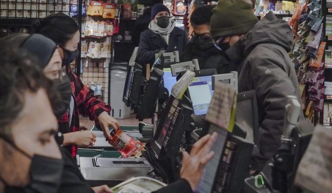 Store clerks and shoppers wear masks at Brooklyn&#x27;s Park Slope Co-Op grocery store, Thursday, Dec. 7, 2023, in New York. (AP Photo/Bebeto Matthews)