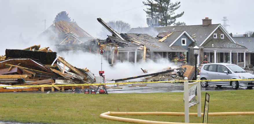 Work crews tear down part of the Bird-in-Hand Family Inn after an early morning fire on Monday, Dec. 18, 2023 in Bird-in-Hand, Pa. (Suzette Wenger/LNP/LancasterOnline via AP)