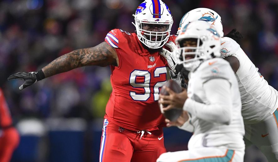 Buffalo Bills defensive tackle DaQuan Jones (92) pressures Miami Dolphins quarterback Tua Tagovailoa (1) during the second half of an NFL football game in Orchard Park, N.Y., Saturday, Dec. 17, 2022. The Buffalo Bills opened a three-week window on Tuesday, Dec. 19, 2023, for starting defensive tackle DaQuan Jones to be activated from injured reserve after missing nine games with a torn pectoral muscle. While the chances of Jones’ being activated are promising, coach Sean McDermott said it was unlikely that will happen in time for Saturday, when Buffalo (8-4) travels to play the Los Angeles Chargers (5-9). (AP Photo/Adrian Kraus, File)