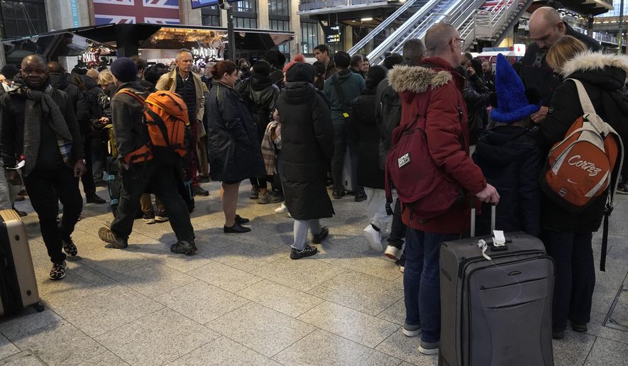 Stranded passengers wait at the Gare du Nord station, Thursday, Dec. 21, 2023 in Paris. The last-minute strike by Eurotunnel operator Getlink began around noon, forcing the train operator to cancel all trains to and from London. Trains between London, Amsterdam and Brussels were also affected. (AP Photo/Michel Euler)