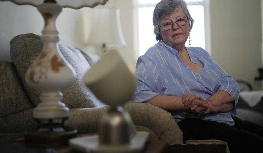 Joyce Loazia interacts with ElliQ, front, a tabletop device that uses artificial intelligence to conduct human-like conversations, during an interview in her apartment in a senior community in Coral Springs, Fla., Tuesday, Dec. 5, 2023. Loazia is among the first in the country to receive the robot ElliQ, whose creators, Intuition Robotics, and senior assistance officials say is the only device using artificial intelligence specifically designed to lessen the loneliness and isolation experienced by many older Americans. (AP Photo/Rebecca Blackwell) **FILE**