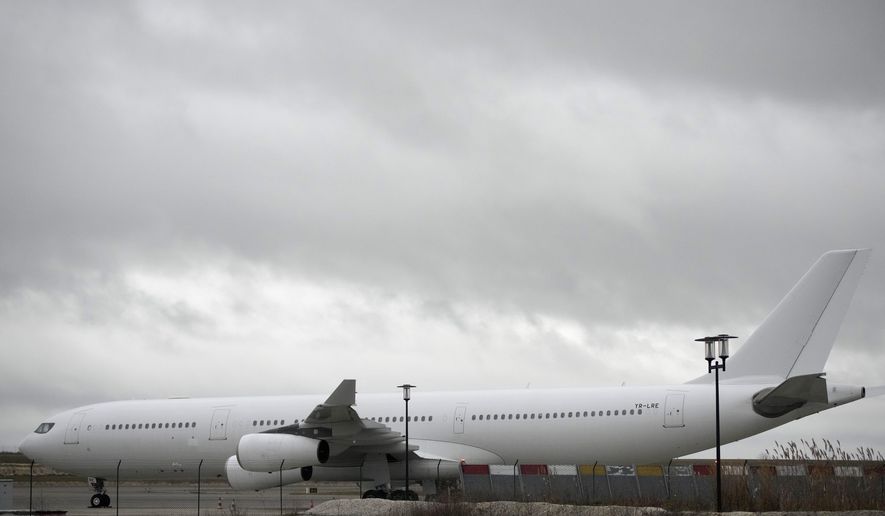 The plane reported to carry some 300 Indian citizens parks at the Vatry airport, eastern France, Saturday, Dec. 23, 2023 in Vatry. About 300 Indian citizens heading to Central America were sequestered in a French airport for a third day Saturday because of an investigation into suspected human trafficking, authorities said. The 15 crew members of the Legend Airlines charter flight en route from United Arab Emirates to Nicaragua were questioned and released, according to a lawyer for the small Romania-based airline. (AP Photo/Christophe Ena)