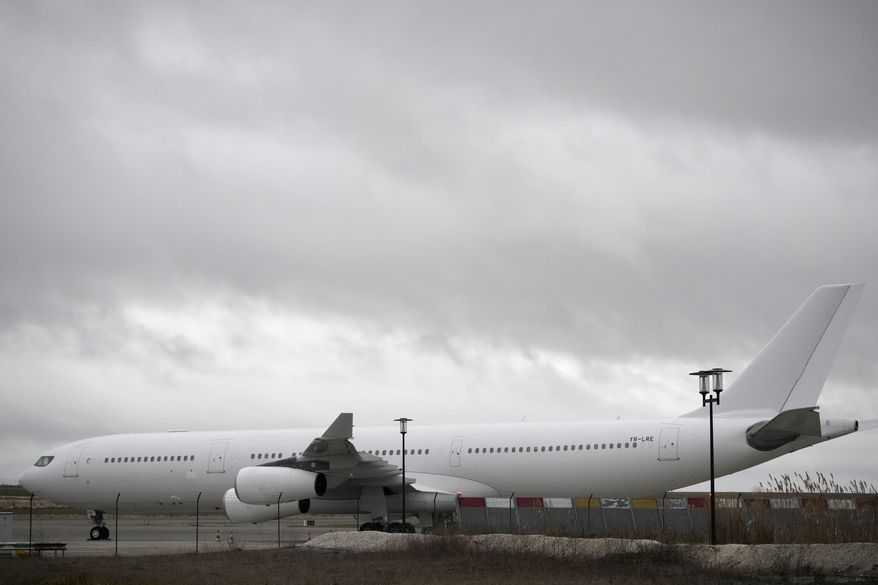 The plane reported to carry some 300 Indian citizens parks at the Vatry airport, eastern France, Saturday, Dec. 23, 2023 in Vatry. About 300 Indian citizens heading to Central America were sequestered in a French airport for a third day Saturday because of an investigation into suspected human trafficking, authorities said. The 15 crew members of the Legend Airlines charter flight en route from United Arab Emirates to Nicaragua were questioned and released, according to a lawyer for the small Romania-based airline. (AP Photo/Christophe Ena)