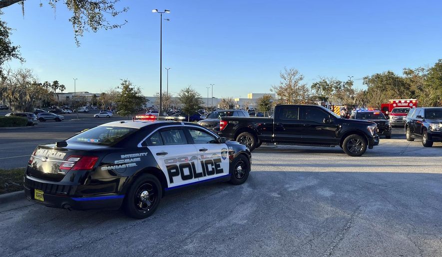 In this photo provided by the Ocala Police Department, a cruiser sits parked following a fatal shooting at Paddock Mall in Ocala, Fla., located about 80 miles northwest of Orlando, Saturday, Dec. 23, 2023. (Jeff Walczak/Ocala Police Department via AP)