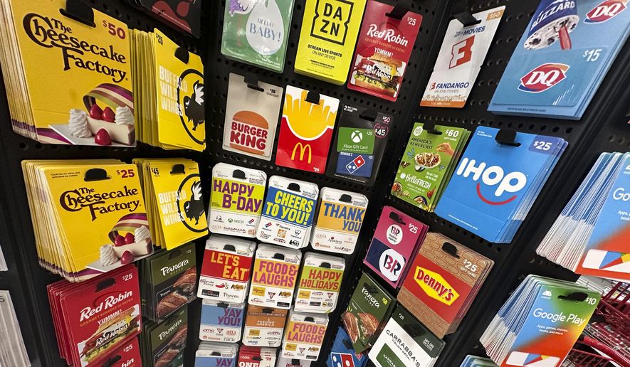 Gift cards are displayed at a Target store, in New York, Thursday, Dec. 21, 2023. Americans are expected to spend nearly $30 billion on gift cards this holiday season, according to the National Retail Federation. Restaurant gift cards are the most popular, making up one-third of those sales. (AP Photo/Richard Drew)